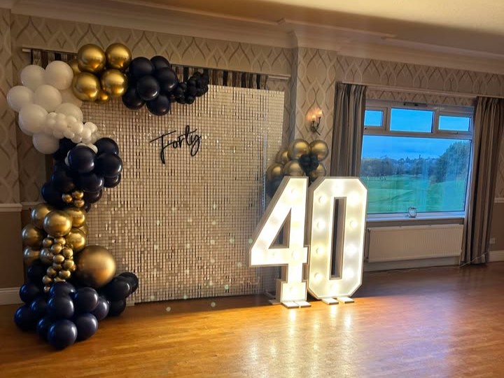 A large light-up 40 and balloon display on the dancefloor at The Manor Leeds.