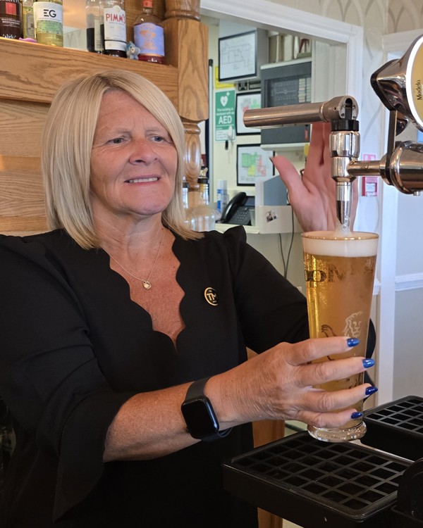 The Manor Events Manager Becky pouring a pint of Modelo.