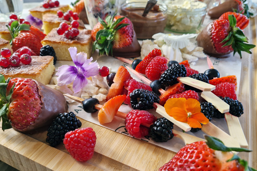 The Fruity One sharing board at The Manor Leeds; mini fruit tarts, berry skewers, lemon drizzle cake and Eton Mess.