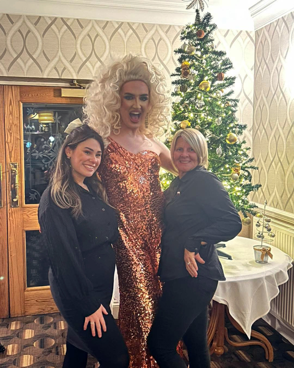 The Manor Events Manager Becky with Assistant Manager Starr posing with a Drag Queen.