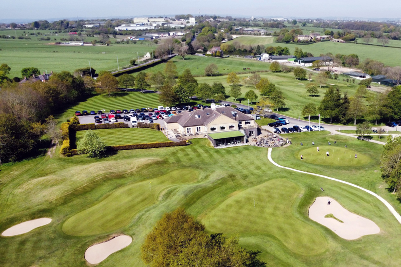 An aerial photo of the rear aspect of The Manor main building. The golf course can be seen in the foreground.