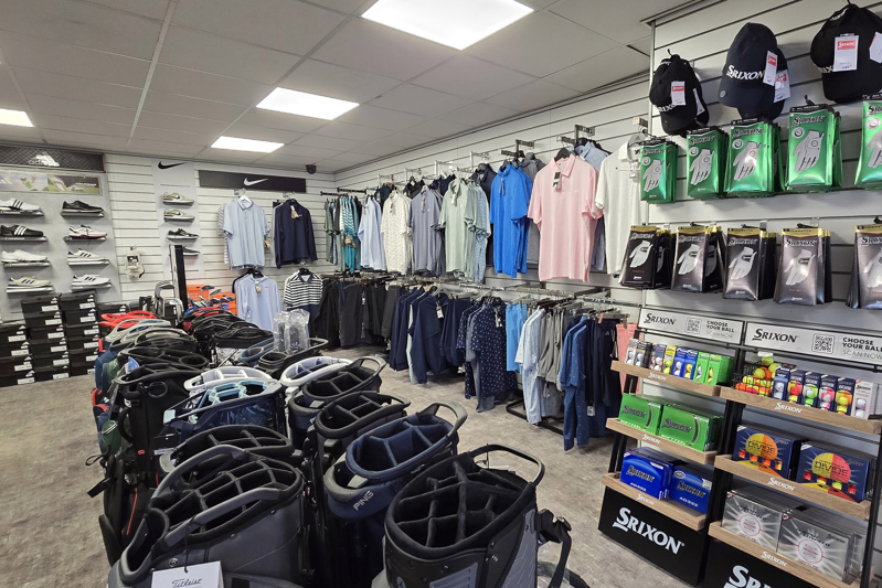 A view of the products on display in The Manor's golf shop; bags, shirts, footwear, hats, gloves and golf balls can be seen.