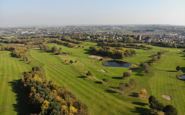 A south-facing aerial photograph looking over The Manor golf course in autumn.