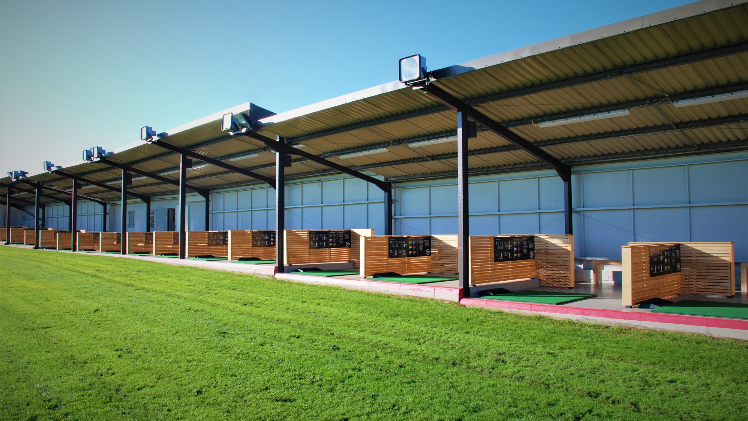 A view into the covered bays of the Driving Range at The Manor Leeds.